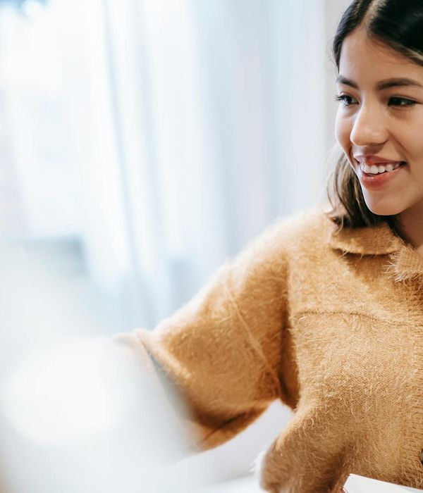 Person stretching gently indoors with soft natural light.
